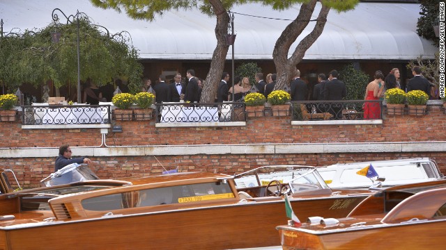 Guests attend a cocktail party at the Hotel Cipriani before the wedding. 