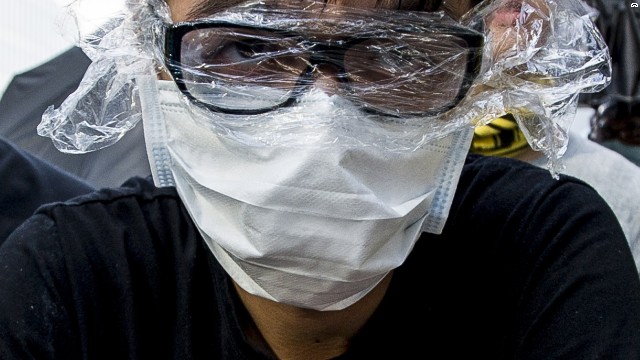 A protester uses a mask and plastic to protect himself from pepper spray during a demonstration at the government headquarters in Hong Kong on Saturday, September 27. 