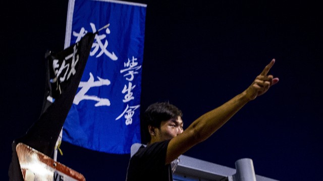 A protestor shouts slogans during a student demonstration in Hong Kong against Beijing's refusal to sanction open elections in the city in 2017. Protesters surrounded the headquarters of Hong Kong's law-making body, the Legislative Council.