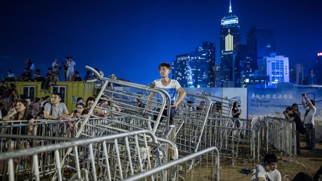 Protesters use barricades to block the road during a rally. Thousands of students from more than 20 tertiary institutions entered a week-long boycott of classes to protest against Beijing's conservative framework for political reform in Hong Kong. 