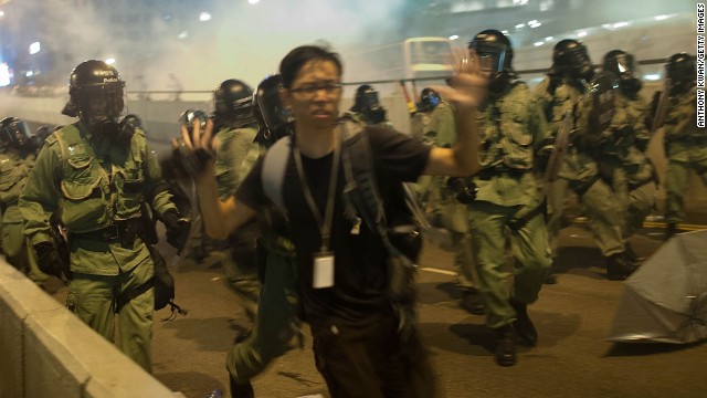 Demonstrators disperse as tear gas is fired during a protest on September 28. There is an "optimal amount of police officers dispersed" around the scene, a Hong Kong police representative said.