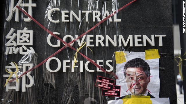 A sign for the Hong Kong central government offices has been crossed out with red tape by democracy activists on September 28. 