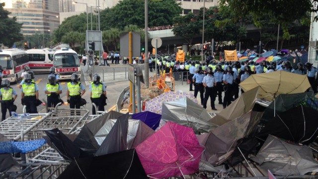 Police in protective clothing line up near the Central Government Offices in Hong Kong. 