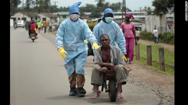 Residents of the St. Paul Bridge neighborhood in Monrovia take a man suspected of having Ebola to a clinic on September 28.