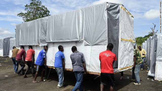 Workers move a building into place as part of a new Ebola treatment center in Monrovia on September 28.