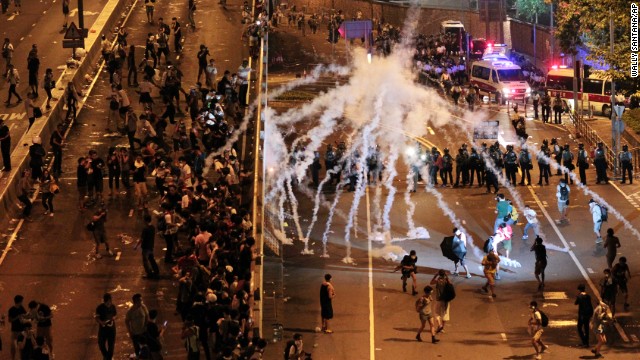 Riot police fire tear gas on student protesters occupying streets around government buildings in Hong Kong on September 29.