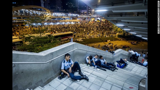 Police officers rest after protests on September 29. 