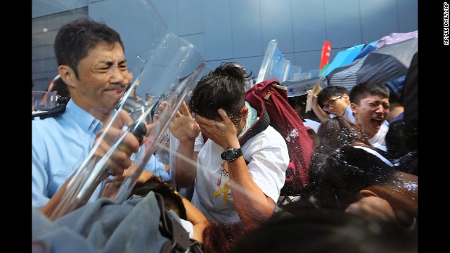Riot police use pepper spray on pro-democracy activists who forced their way into the Hong Kong government headquarters during a demonstration on September 27.