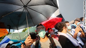 Protesters used umbrellas to block pepper spray and tear gas used by riot police.