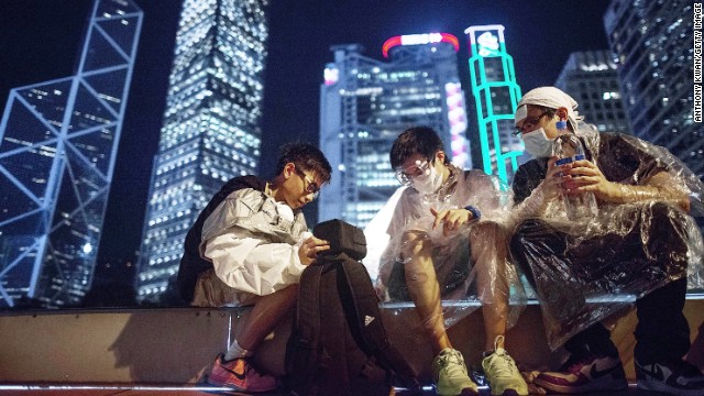 Before the distinctive backdrop of Hong Kong's high-rise skyline, protesters suit up in goggles and plastic ponchos to protect themselves against the possible use of tear gas by authorities. Demonstrators were gassed by Hong Kong police on Sunday.