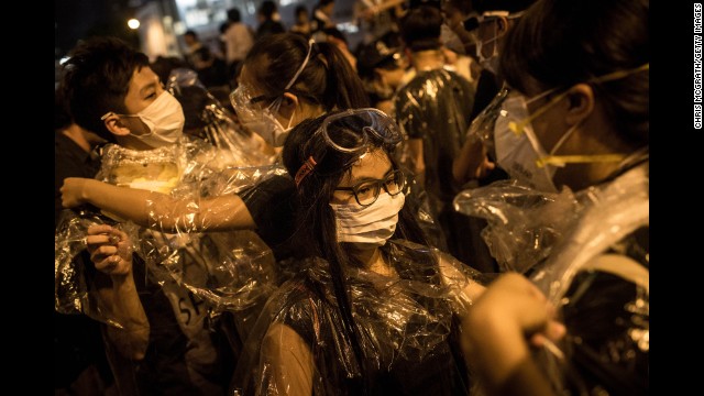 Protesters put on goggles and wrap themselves in plastic on September 29 after hearing a rumor that police were coming with tear gas.