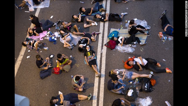 Protesters sleep on the streets outside the Hong Kong Government Complex at sunrise on September 30.