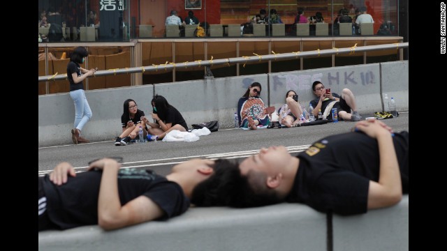 Pro-democracy demonstrators sleep on the street outside a government complex in Hong Kong on Thursday, October 2.