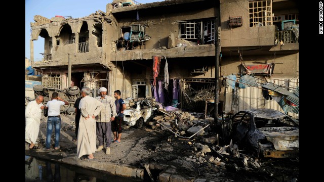 People inspect the site of a double car bombing in Baghdad on Wednesday, October 1. The United Nations said Wednesday that at least 1,119 Iraqis were killed in September in acts of terrorism and violence.