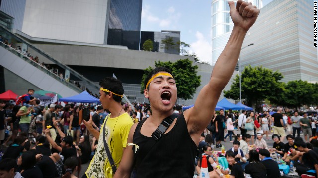 A pro-democracy activist shouts slogans on a street near the government headquarters on Wednesday, October 1.