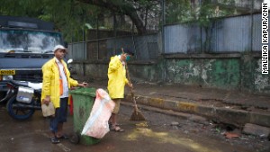 Ganesh Shinde (right) with his colleague doing their job on the streets of Mumbai.