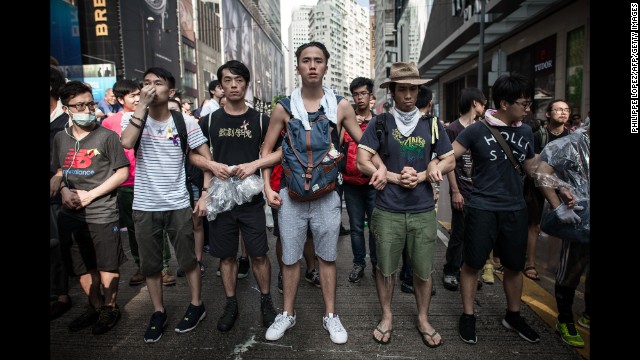 Pro-democracy demonstrators protect a barricade from "anti-Occupy" crowds in Hong Kong on October 3. 