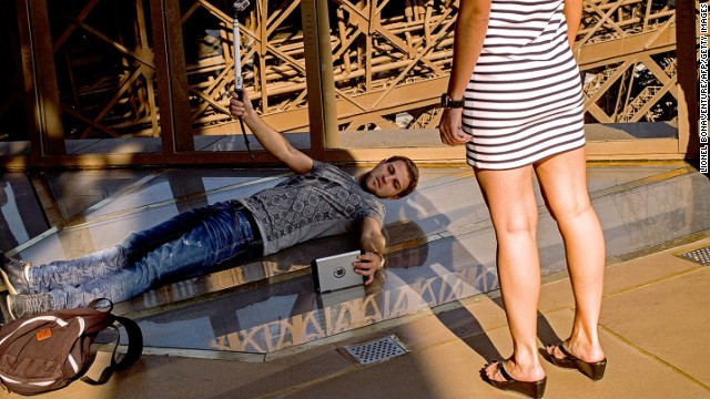 Visitors are lining up -- and lying down -- to experience the Eiffel Tower's new glass floor.