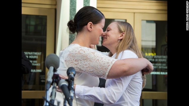 Jennifer Melsop, left, and Erika Turner kiss after they were married in front of the Arlington County Courthouse in Arlington, Virginia, on October 6.