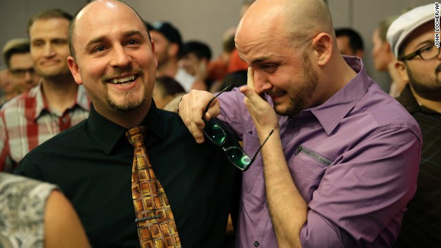 Joshua Gunter, right, and Bryan Shields attend a rally in Las Vegas to celebrate an appeals court ruling that overturned Nevada's same-sex marriage ban on Tuesday, October 7.