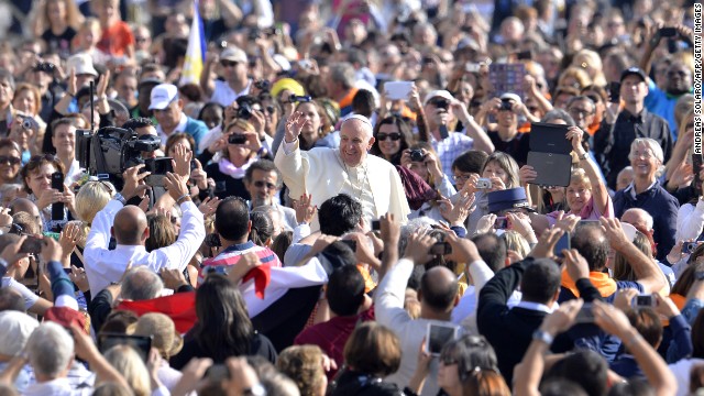 Pope Francis greets the crowd as he arrives for his general audience at St. Peter's Square at the Vatican on Wednesday, October 8. With his penchant for crowd-pleasing and spontaneous acts of compassion, the Pope has earned high praise from fellow Catholics and others since he replaced Pope Benedict XVI in March 2013.