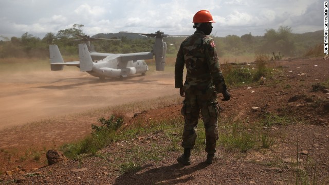 A member of the Liberian army stands near a U.S. aircraft Saturday, October 11, in Tubmanburg.