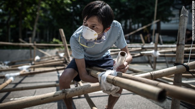 A demonstrator sets up a new barricade made of bamboo in Hong Kong on October 13.