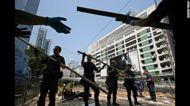 Police remove bamboo that pro-democracy protesters had set up to block off main roads on October 14. 