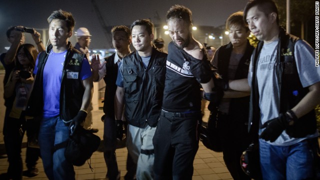 Pro-democracy demonstrator Ken Tsang gets taken taken away by police before allegedly being beaten up in Hong Kong on October 15. Authorities have vowed to conduct an investigation into a widely circulated video that appears to show plainclothes officers kicking and punching the man. 