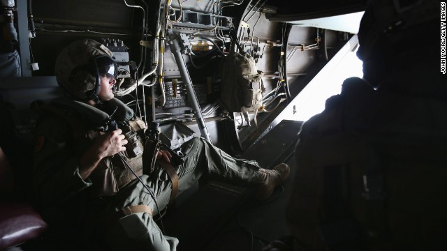 A U.S. Marine looks out from an MV-22 Osprey aircraft before landing at the site of an Ebola treatment center under construction in Tubmanburg on October 15. It is the first of 17 Ebola treatment centers to be built by Liberian army soldiers and American troops as part of the U.S. response to the epidemic.