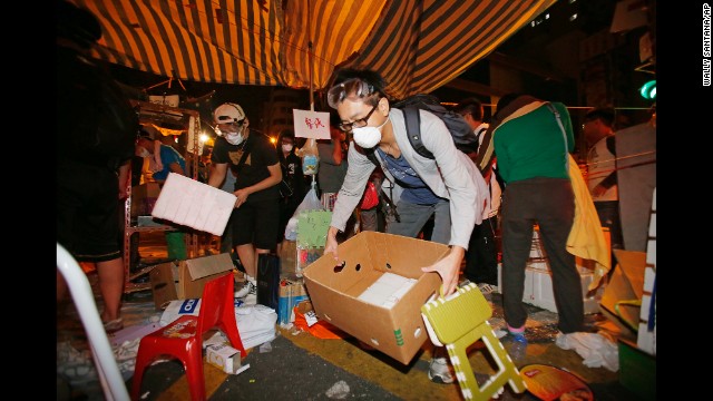 Demonstrators remove their belongings from a protest camp early on October 17.