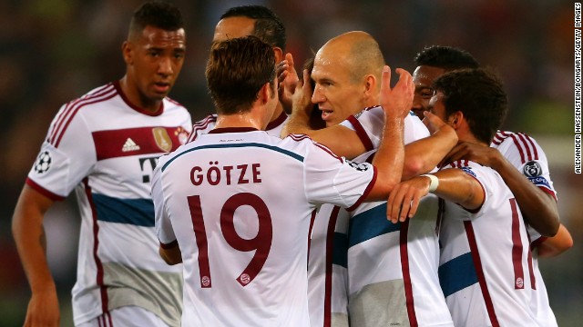 Bayern Munich's Dutch playmaker Arjen Robben is mobbed by his teammates after scoring the opening goal against AS Roma in the Italian capital. The German champions would go on to score six more.
