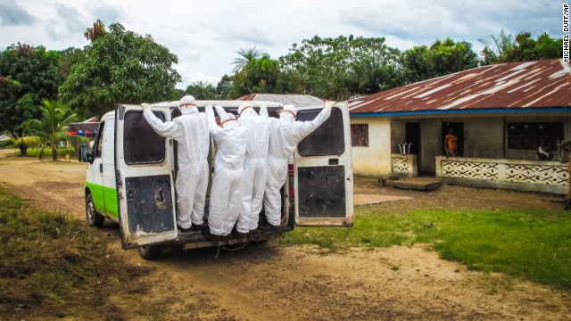 Health workers in Port Loko, Sierra Leone, transport the body of a person who is suspected to have died of Ebola on Tuesday, October 21.