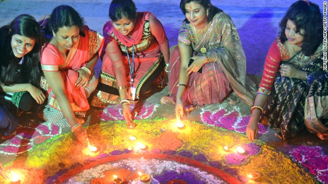 Indian women pose with earthen lamps ahead of Diwali, the Hindu festival of lights, in Siliguri on October 19.