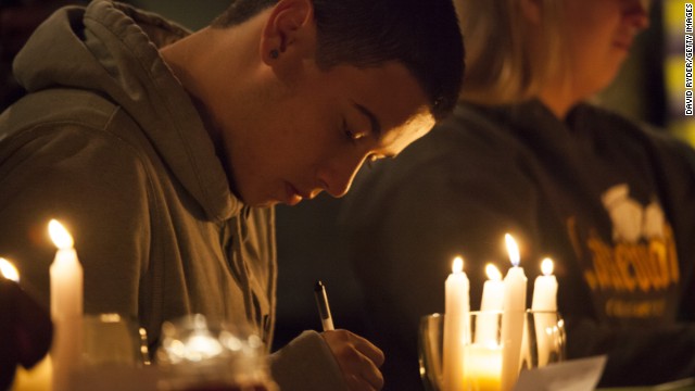 Students from Marysville-Pilchuck High School write messages and prayers during a vigil Friday, October 24, at a church in Marysville, Washington. Earlier in the day, <a href='http://www.cnn.com/2014/10/27/us/washington-school-shooting/index.html'>a student shot five people at the school</a> before he committed suicide, law enforcement officials told CNN.