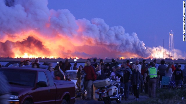 People who came to Wallops Island, Virginia, to watch the launch walk away after the unmanned rocket, owned by Orbital Sciences Corp., exploded.