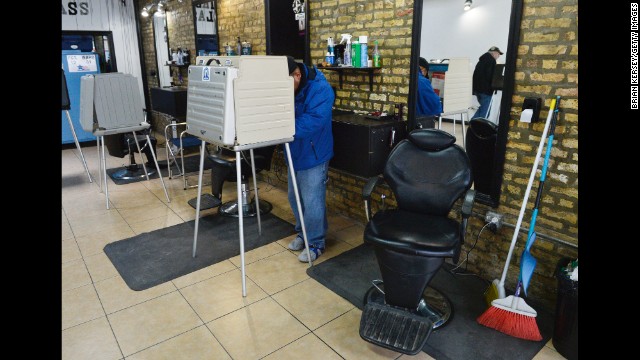 Voters cast their ballots at First Class Barber Shop in Chicago.