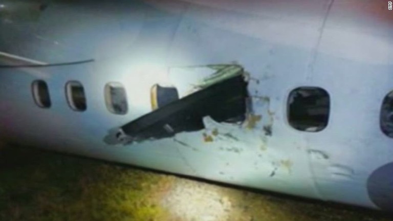 Propeller Crashes Through Plane Window, Hits Passenger - CNN Video