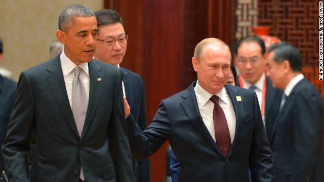 Russian President Vladimir Putin, right, passes U.S. President Barack Obama at the Asia-Pacific Economic Cooperation summit in Beijing on Tuesday, November 11. Putin had brief conversations with the leaders of Vietnam, Indonesia, Australia and the United States during breaks between official APEC summit events.