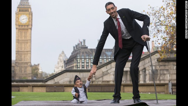 Chandra Bahadur Dangi, at 21½ inches the shortest adult ever verified by Guinness World Records, poses Thursday in London with the world's tallest man, Sultan Kosen, who stands 8 feet 3 inches tall. 