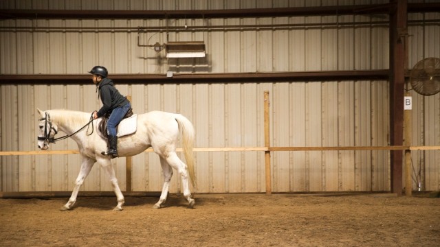 A child takes riding lessons at the center. "When you teach a child to ride a horse, they learn they are the center of their environment," Kelly said. "Once they make that connection, they can change what happens in school, at home and in the community."