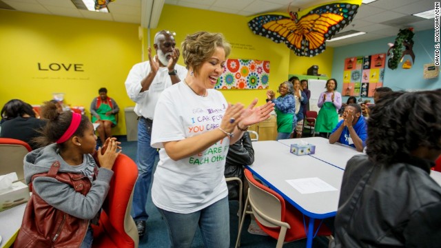 Program participants and volunteers chant at the start of a Roberta's House peer support session in Baltimore. Annette March-Grier, center, founded Roberta's House to help children and their families cope with grief -- particularly the trauma of losing a loved one.