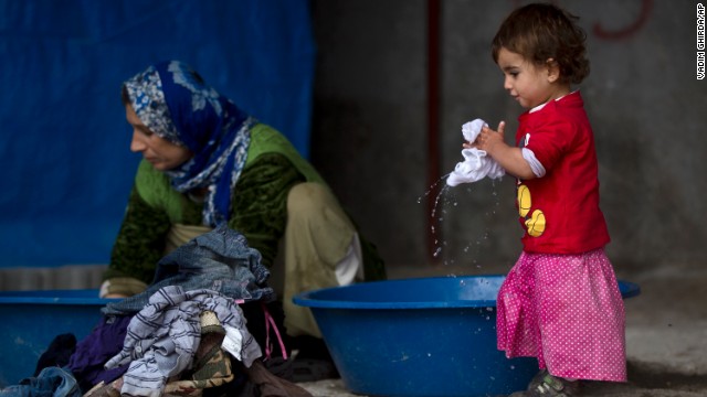 A Syrian Kurdish refugee child from the Kobani area holds laundry on a cold morning at a camp in Suruc, on the Turkey-Syria border, on Monday, November 17. Kobani, also known as Ayn Arab, has been under assault by extremists of the Islamic State group since mid-September and is being defended by Kurdish fighters. ISIS has been advancing in Iraq and Syria as it seeks to create an Islamic caliphate in the region.