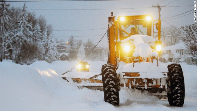 A grader moves snow in Lancaster, New York, on Wednesday, November 19. A ferocious storm dumped massive piles of snow on parts of upstate New York, trapping residents in their homes and stranding motorists on roadways, as snowstorms and record-low temperatures hit much of the country this week.