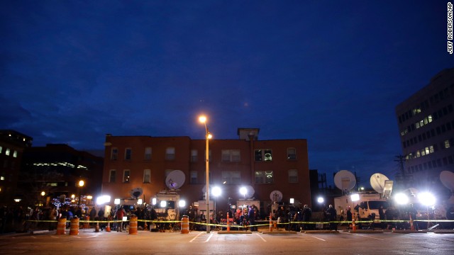 Members of the media line up in a parking lot across from the Buzz Westfall Justice Center on November 24.