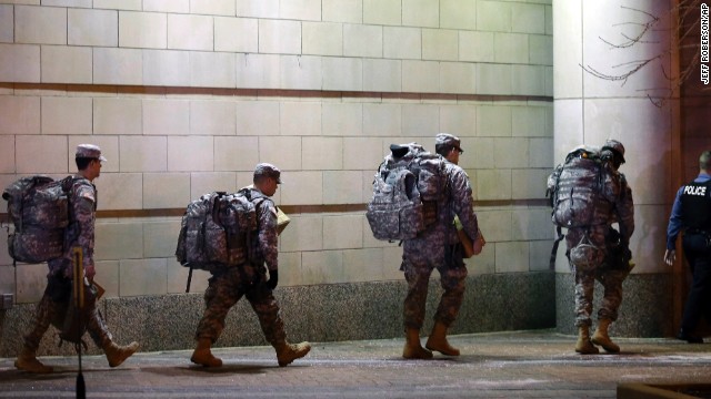 Members of the Missouri National Guard are escorted out of the Buzz Westfall Justice Center. 