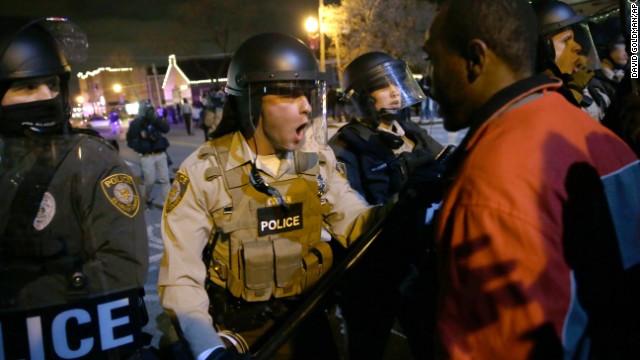 Police officers confront protesters on November 24.