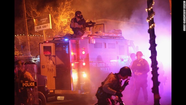 Police confront protesters in Ferguson on November 24.