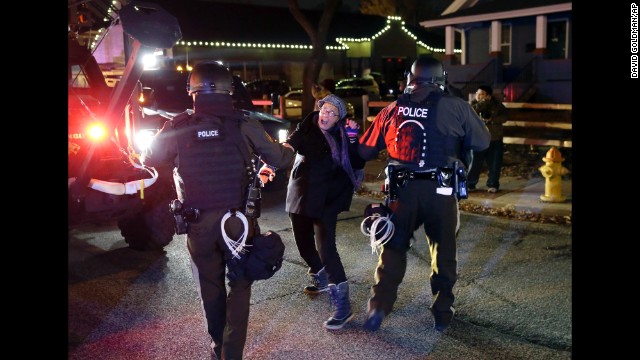 Police officers grab a protester on November 24.