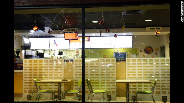 The glass windows of a store are shattered on November 24.